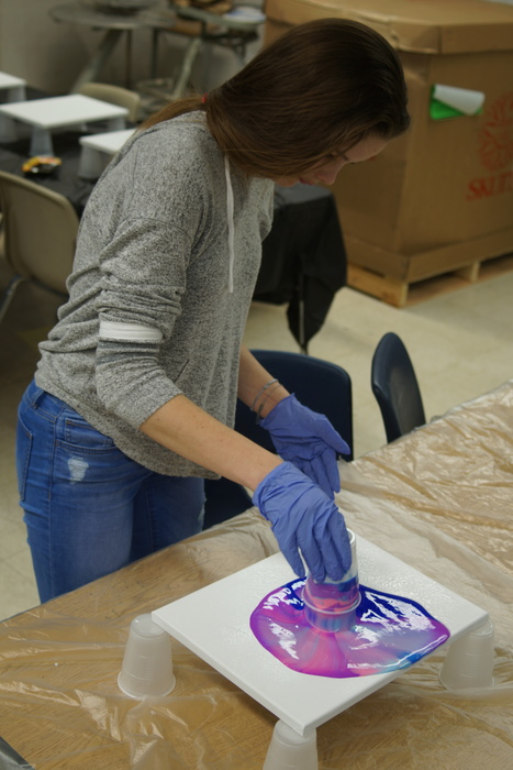 Student creating acrylic painting
