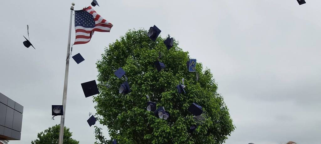 graduation caps flying in the air